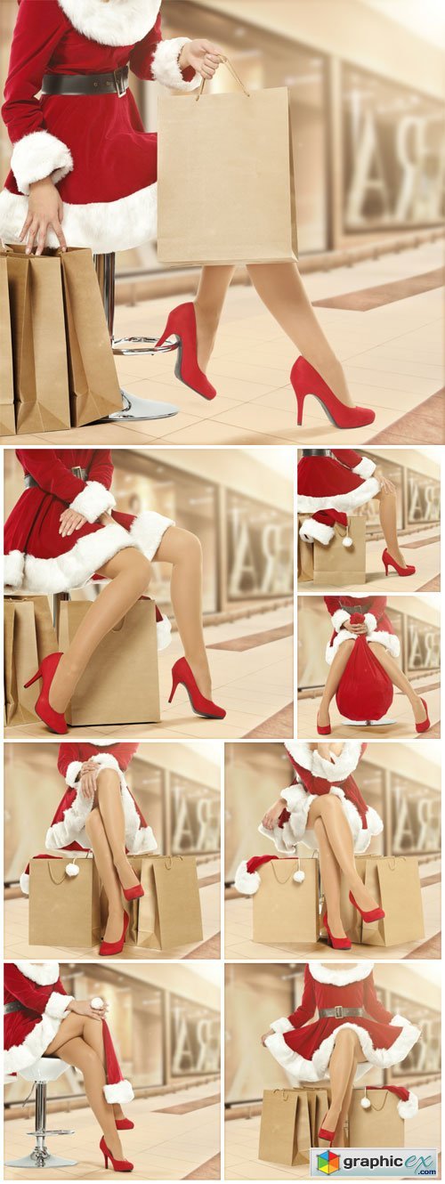Christmas shopping, girl dressed as Santa - Stock photo
