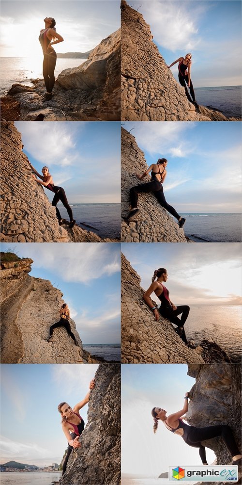 Female rock climber climbs on rocky wall