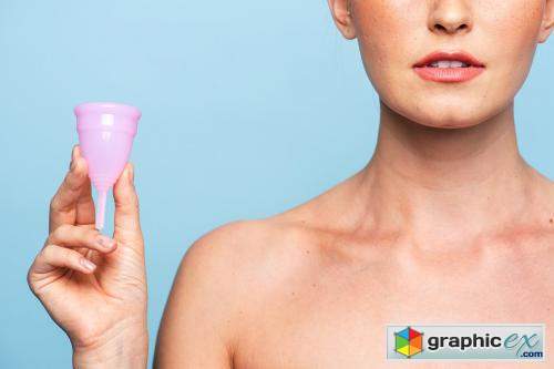 Woman holding pink menstrual cup
